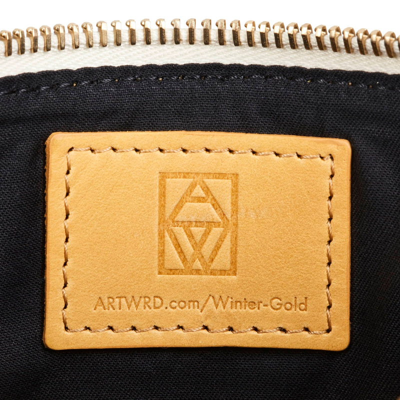 Art bag leather label embossed with the ART WRD logo and a web address for exploring the artist and writer that created this product.