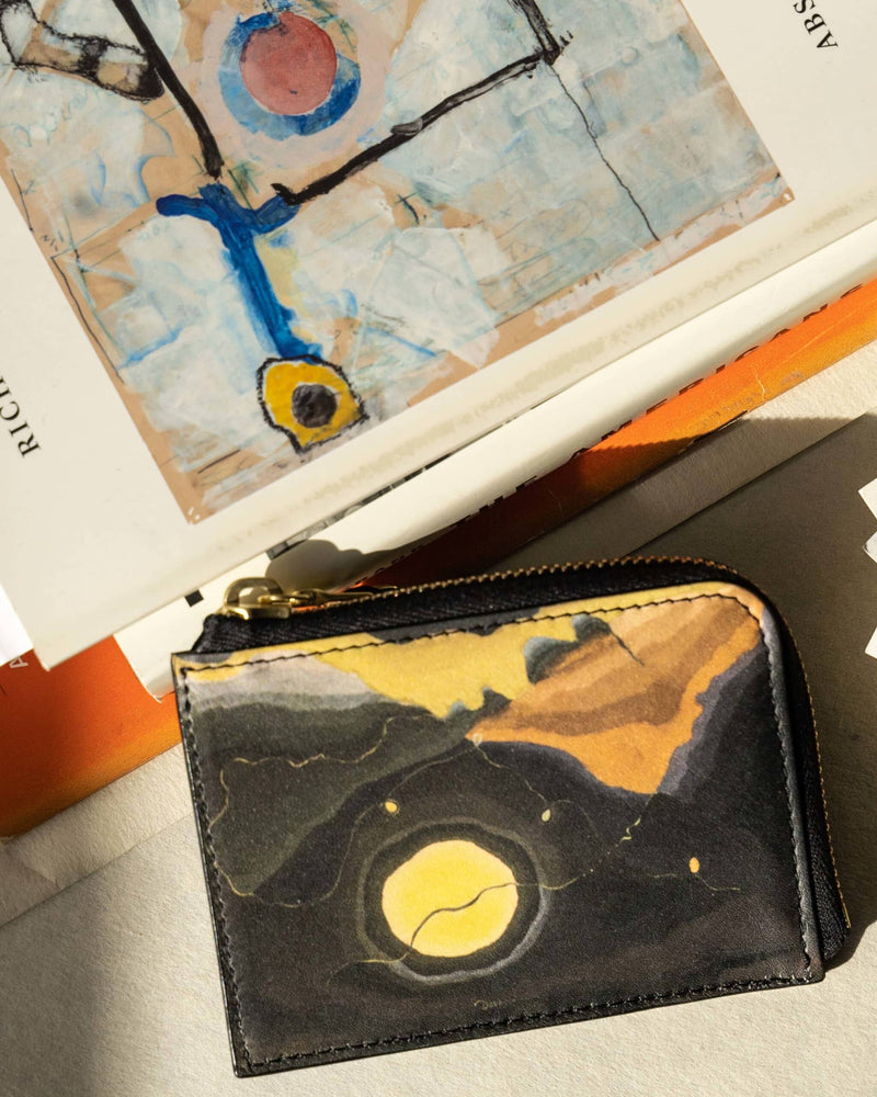 Creative wallet with Arthur Dove 'Me And The Moon' artwork arranged with art books.
