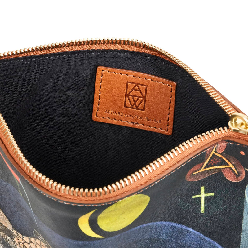 View of black cotton lined inner of a unique paul klee fish artwork bag. A brown vegetable tanned leather label is visible embossed with the ART WRD logo and a web address for exploring the artist and writer that created this bag.