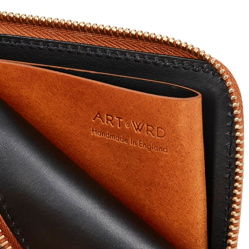 Inside view of the unique art print purse showing tan colour leather coin well pocket.