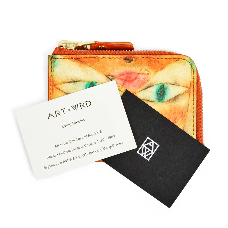 ART WRD information cards on top of unusual wallet purse with cat artwork by Paul Klee.