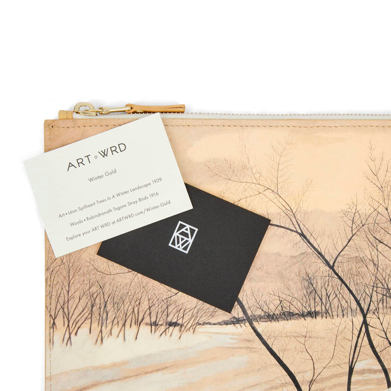 ART WRD artist and writer information cards laying on top of an art bag printed with a tree painting by Léon Spilliaert.