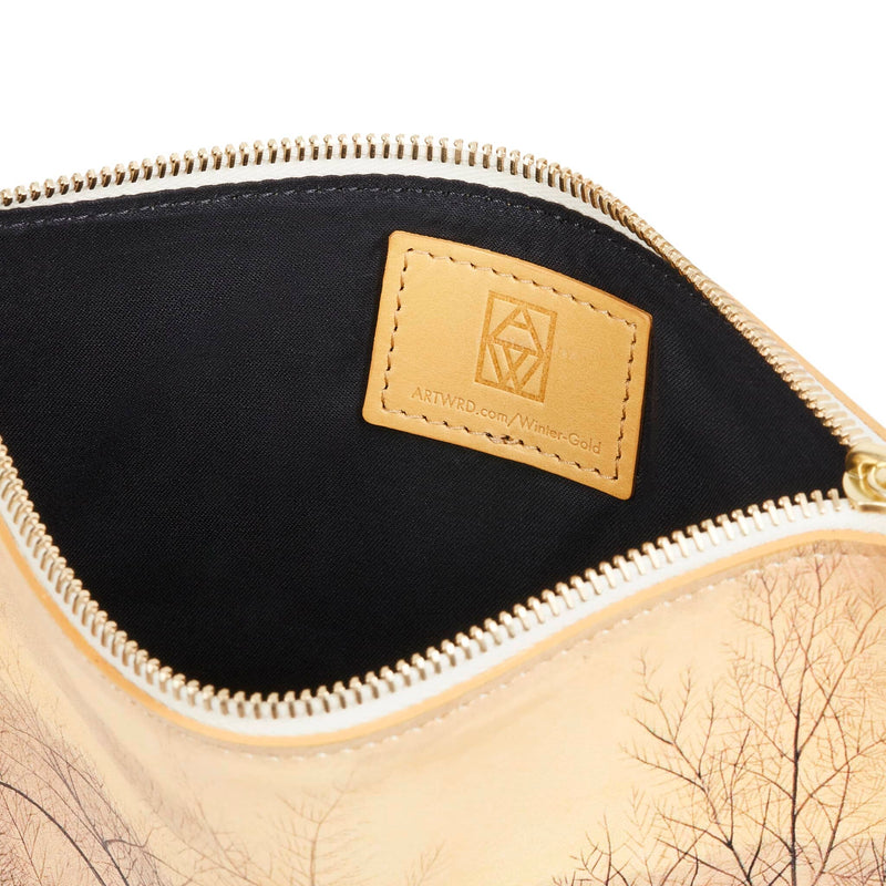 Inside view of an art bag showing a cotton lining and an Italian vegetable tanned leather label. It is embossed with the ART WRD logo and a web address for exploring the writer and artist that created this product.