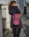 Bright pink tie-dye bag with Aubrey Beardsley witches design. 