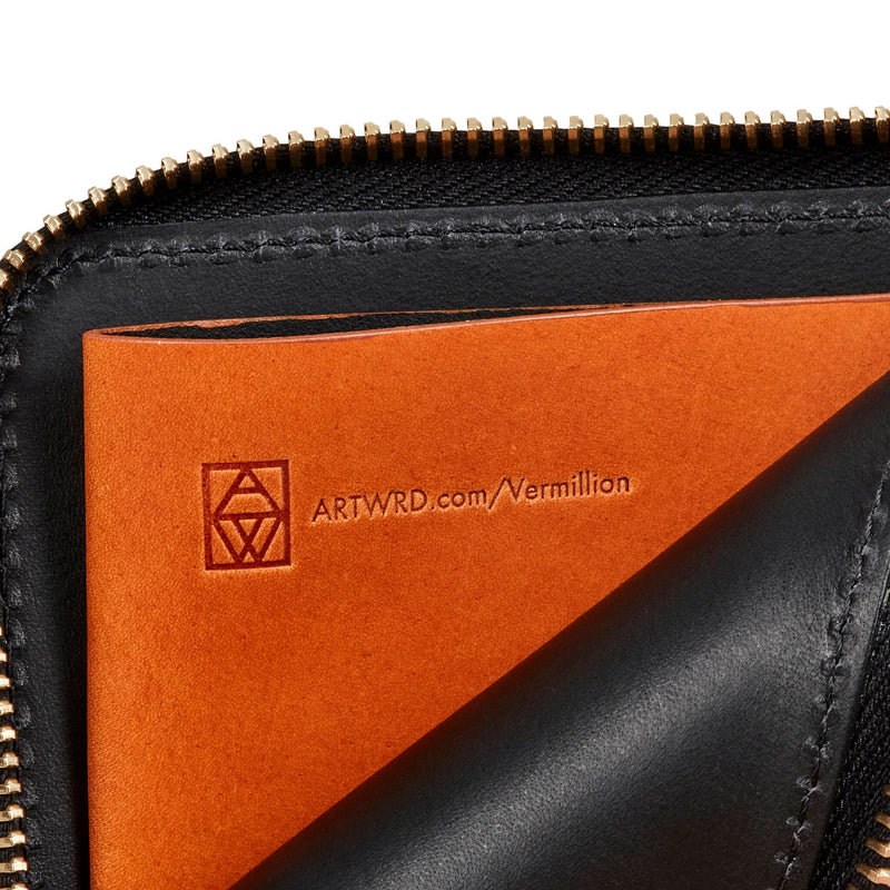 Inside view of a cool unique wallet purse shows a brown Italian vegetable tanned leather coin pocket. It's embossed with a web address to explore the artist and writer that created this wallet.