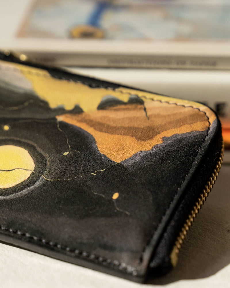 Close up of a creative wallet with Arthur Dove 'Me And The Moon' artwork arranged with art books.