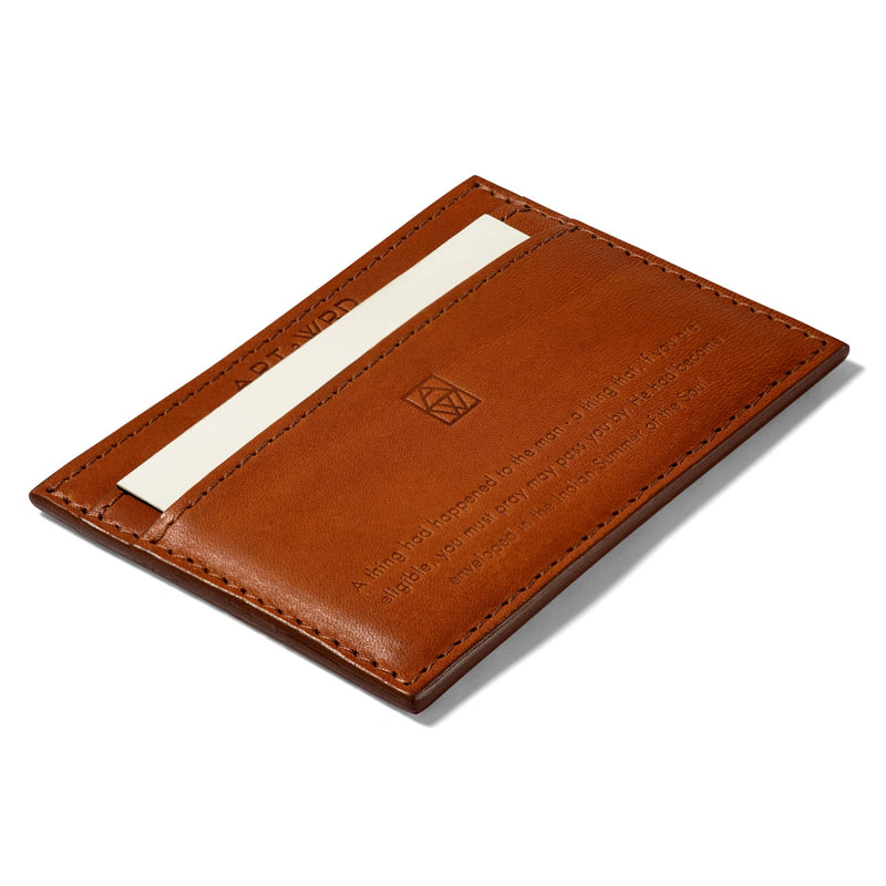 Ethical card holder reverse made with non-toxic vegetable tanned leather and embossed with an O Henry quote. A white card is inserted in bottom card slot.