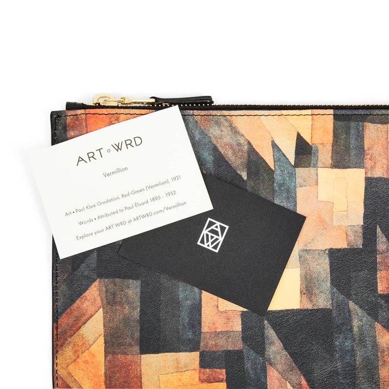 ART WRD artist and writer information cards laying on a leather art pouch printed with Paul Klee art.