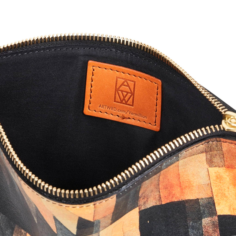Open leather art pouch showing cotton lining and Italian vegetable tan label. This is embossed with a web address for exploring the artist and writer that created this product. 