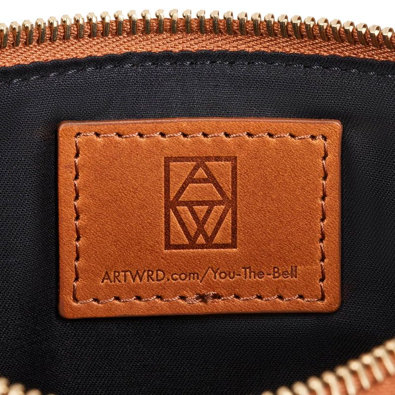 Brown Italian vegetable tanned leather label embossed with the ART WRD logo and a web address for exploring the writer and artist who created this unique bag.