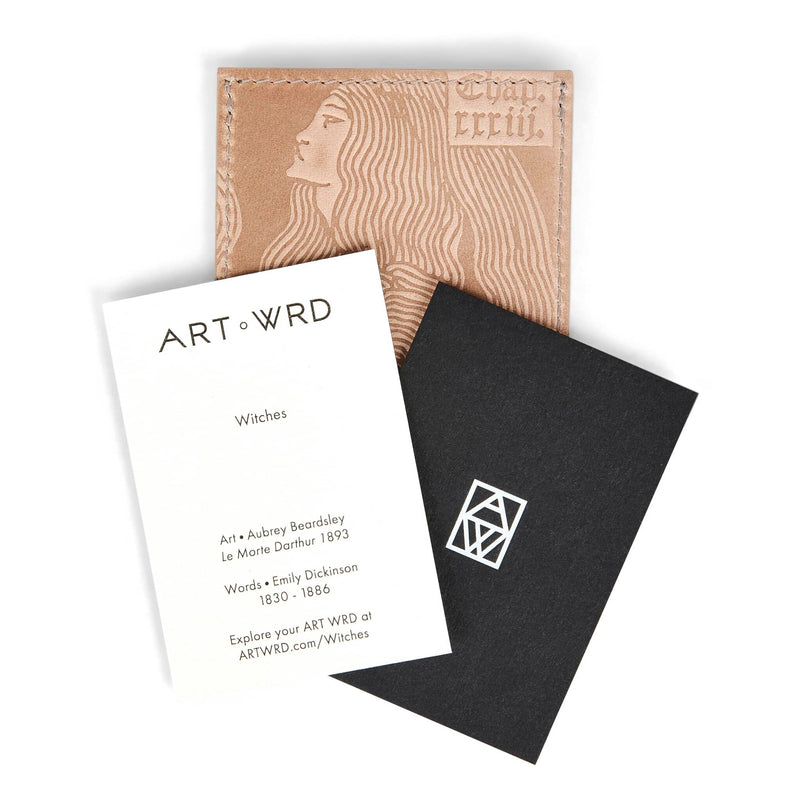 Artist and writer information cards on top of  a unique card holder wallet embossed with an Aubrey Beardsley witches artwork.